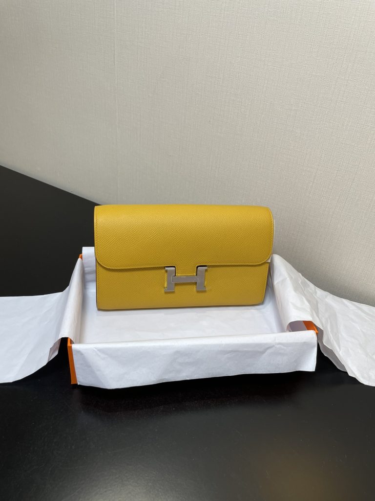 Constance To Go — 20.5 × 13 × 2 cm — Amber Yellow — Epsom leather — Gold-tone hardware