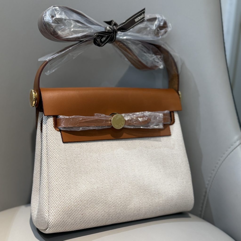 Mini Herbag — a canvas body with leather trim — Gold-tone or silver-tone hardware